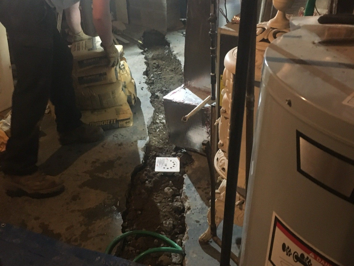 Plumbing work underway beside residential water equipment